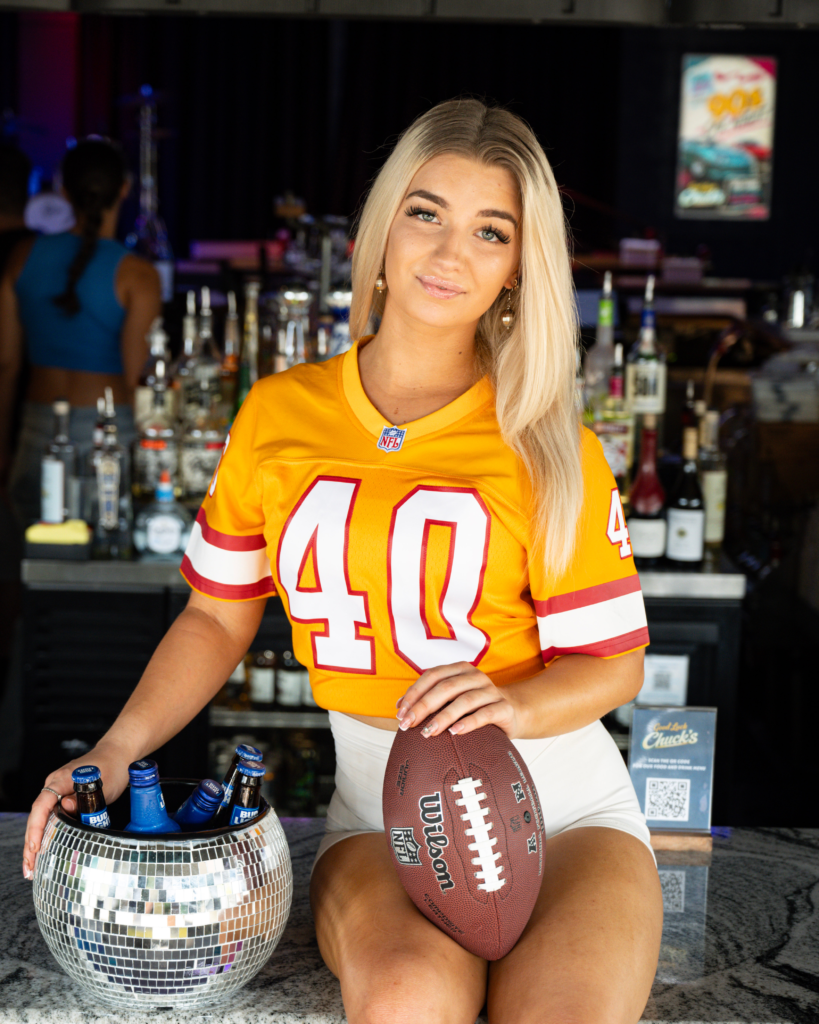 picture of a blonde girl promoting football at Good Luck Chuck's for the best place to watch football in tampa